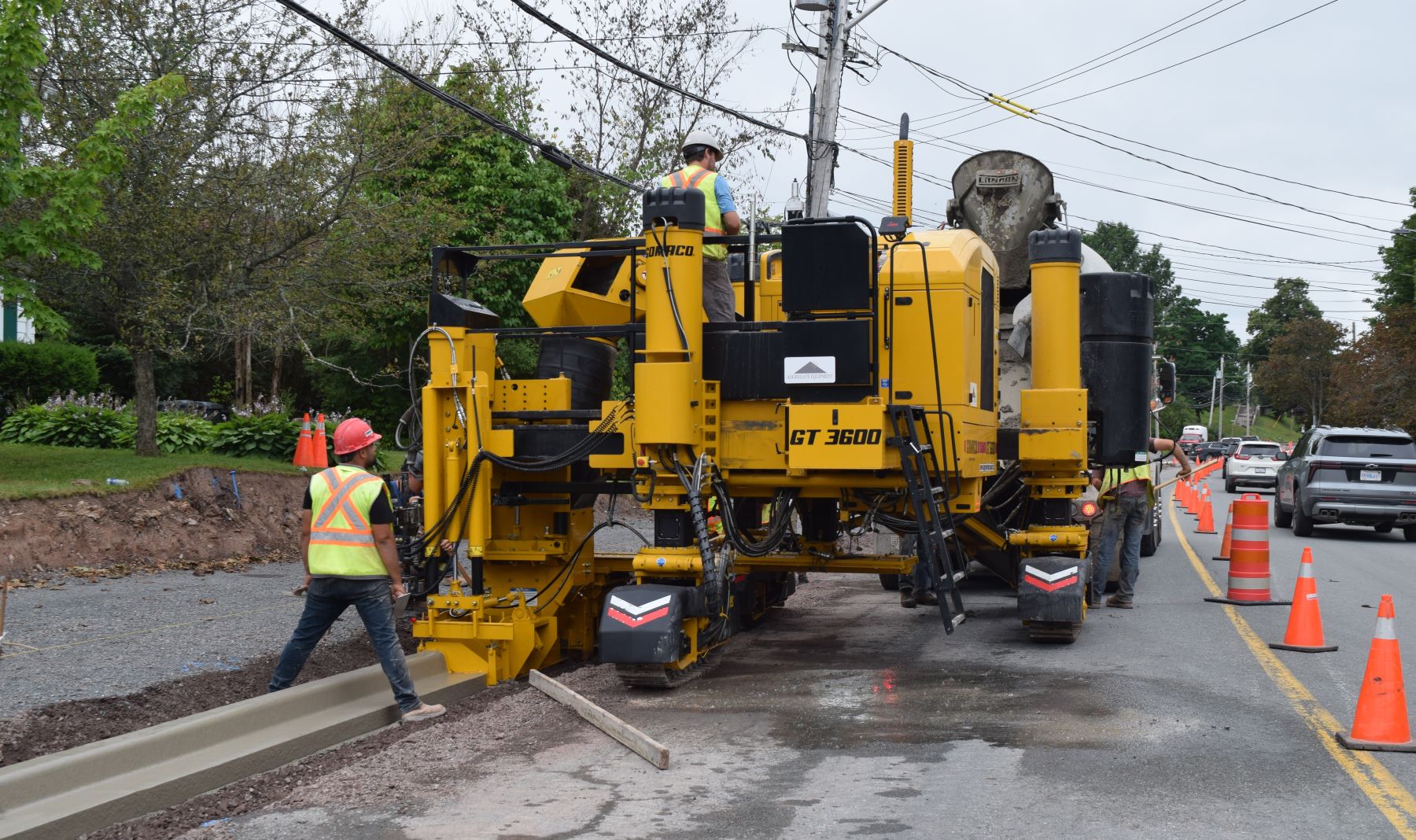 Image showing a curb machine travelling along a roadway to install fresh curb.