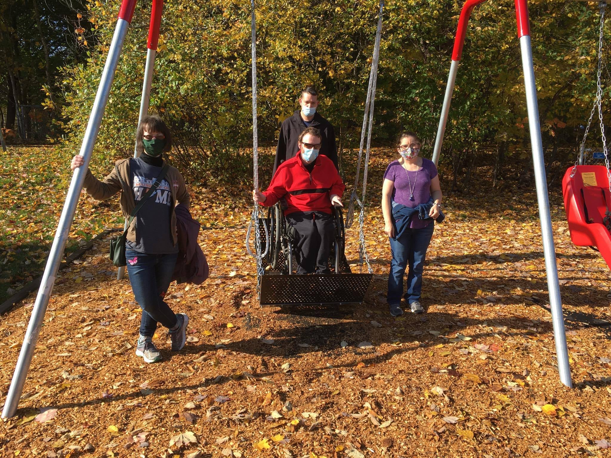 Daniel MacDonald and friends enjoy the accessible swing at Columbus Field. 